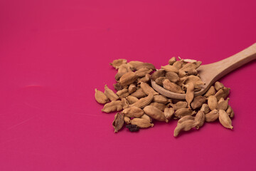 Cardamom herbs over red background