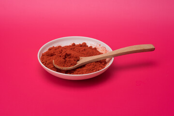 Chili powder over red background