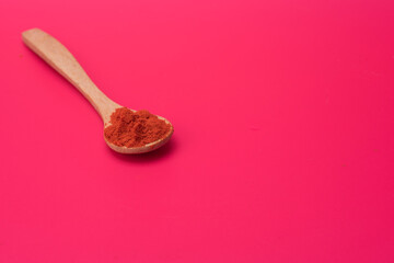 Chili powder over red background