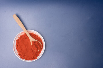 Chili powder over blue background