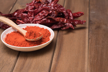 Chili poder over wooden background,high angle shot.