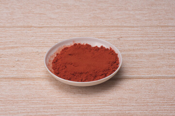 Chili poder over wooden background,high angle shot.