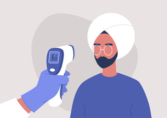 Covid-19 prevention, a hand holding a body Medical Infrared Thermometer, a young indian male patient