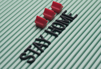 Stay at home messasge over green surface