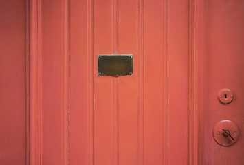 a painted wooden door with a brass plate