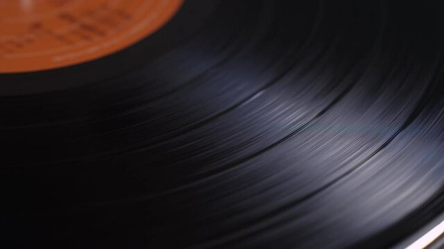 Close up of a vinyl music record spinning on a turntable playing music
