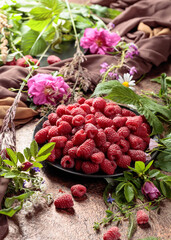 Summer still life with, raspberries, flowers and meadow grasses.