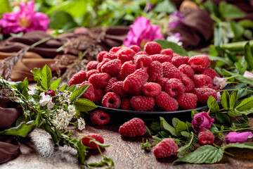 Summer still life with, raspberries, flowers and meadow grasses.