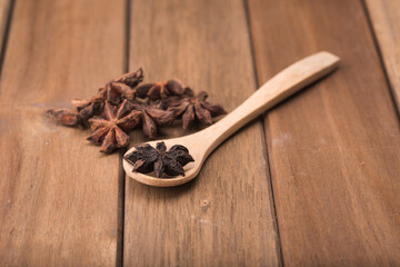 Star anise isolated over wooden background