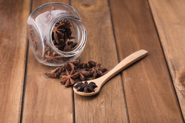 Star anise isolated over wooden background