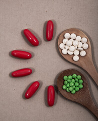 Pills and colored capsules out of the package. Color tablets and capsules from the wing view.