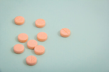 Some pills and white capsules. Pills and capsules together outside the package in the container.