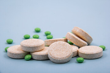 Pills and colored capsules out of the package. Color tablets and capsules from the wing view.