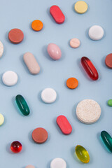 Pills and colored capsules out of the package. Color tablets and capsules from the wing view.