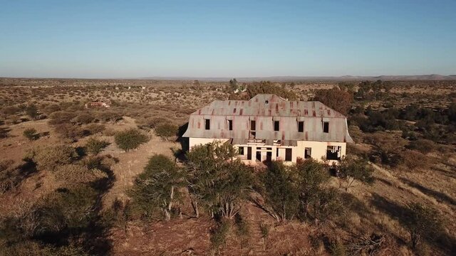4K aerial drone video of Africa savanna hills, plains and abandoned dilapidated old colonial mansion near Neuheusis west of Windhoek in central highland Khomas Hochland of Namibia, southern Africa