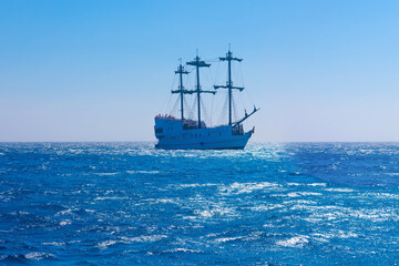 Fototapeta na wymiar Seascape with sailing ship on sunset.