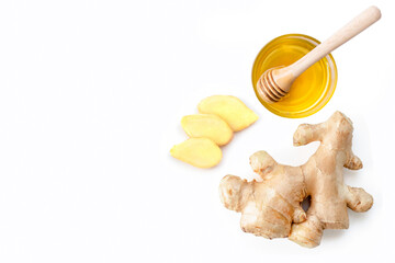 Closeup fresh organic ginger root with slice and pure honey  isolated on white background. Top...