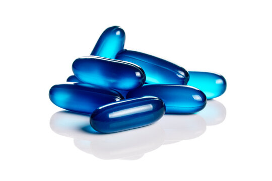 Close up of blue soft gel capsules isolated on the white background