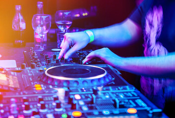 Dj mixes the track in nightclub at party. Body part on the DJ's music control panel