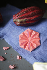 On a blue background, chocolate bar and kkao fruits.
