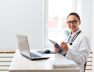 portrait of a smiling female doctor at her workplace