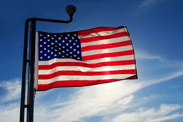 American flag against the sky at sunset evening