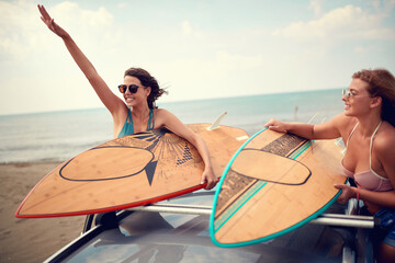 Sexy female surfers preparing for a trip