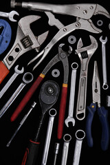 Industrial tools such as French wrenches and a variety of wrenches from a close-up in the form of color and black and white images.