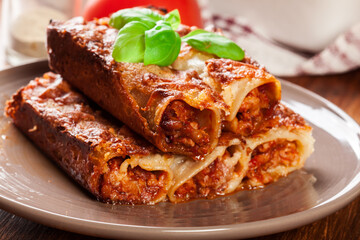 Baked cannelloni with minced meat and bechamel sauce on a plate