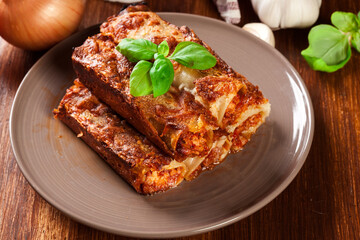 Baked cannelloni with minced meat and bechamel sauce on a plate