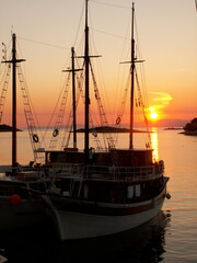 Setting sun through boats in Mljet Croatia