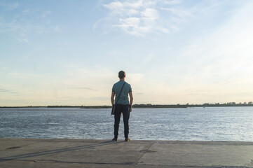 Lonely man looks at the water.