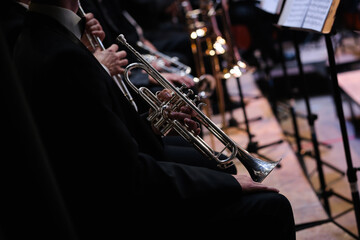 Fototapeta premium the classical musician holds a pipe or a tambourine in his hands. close-up. symphonic music