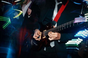 Obraz na płótnie Canvas rock band performing. guitarist plays guitar solo