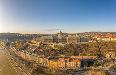 Fototapeta na wymiar Aerial drone shot of Buda Castle palace facade on hill in Budapest sunrise glow