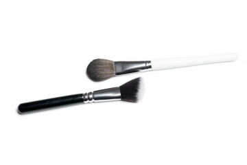 Professional makeup brushes isolated on a white background.