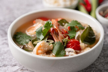 Food and drink, traditional Thai cuisine. Spicy tom yam kung, tom yum sour soup with shrimp, prawn, coconut milk, lemongrass and chili pepper in a bowl