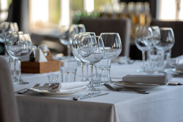 Empty glasses in restaurant background. Table set for an event party or wedding reception.