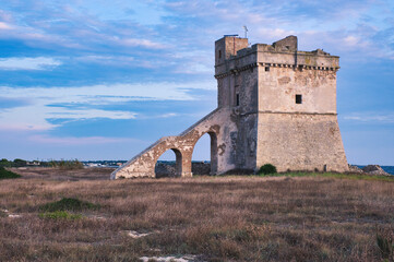 Fototapeta premium seascape at sunset rocks beach sea cloudy sky towers salento apulia 