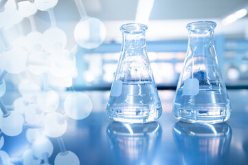 two blue science flask with chemistry molecular structure in blue laboratory background