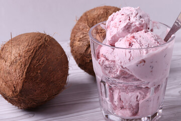 tasty cold melting strawberry and raspberry icecream in a glass container. close up shot.