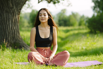 yoga in nature. copycpase woman sitting in a pose. Asiatic