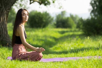 yoga in nature. copycpase woman sitting in a pose. Asiatic.