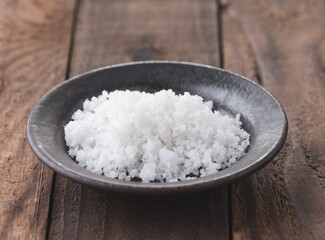 salt in old dish on wood