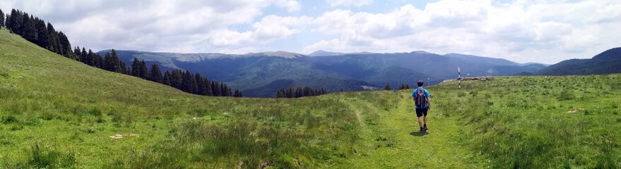 Fototapeta na wymiar Mountain landscape in the summer - hiker on the trail 