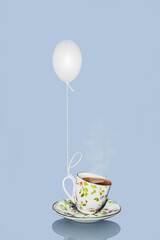 Chicken egg as a balloon raises a cup of coffee