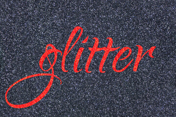 Glitter lettering word red (grenadine) on gray (midnight blue black) sparkle texture. Shiny background
