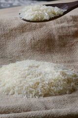 Raw Basmati Rice with wooden spoon side lighting