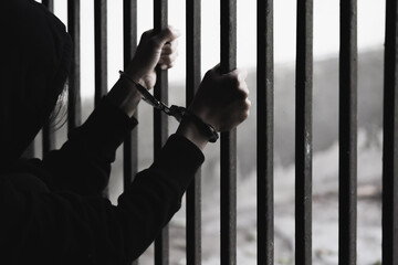 Obraz premium The slave girl was handcuffed and kept in a cage. Imprisonment, Female prisoner, Women violence and abused concept, human trafficking Concept, international women's day.