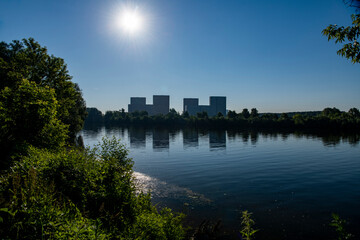 Fototapeta premium modern houses by the lake appear in the water at dawn